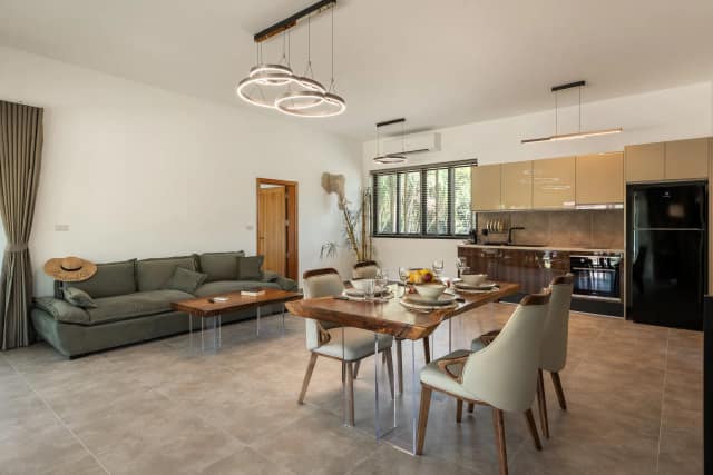 Deluxe villa kitchen with stovetop, oven, and fridge