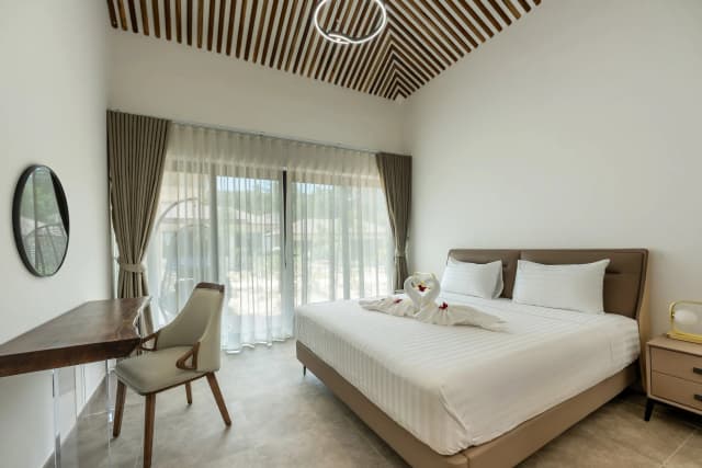Deluxe villa bedroom with quality mattress and air conditioning