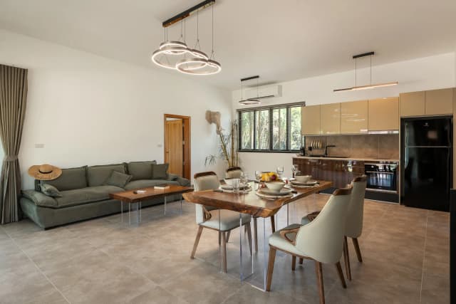 Deluxe villa kitchen with stovetop, oven, and fridge