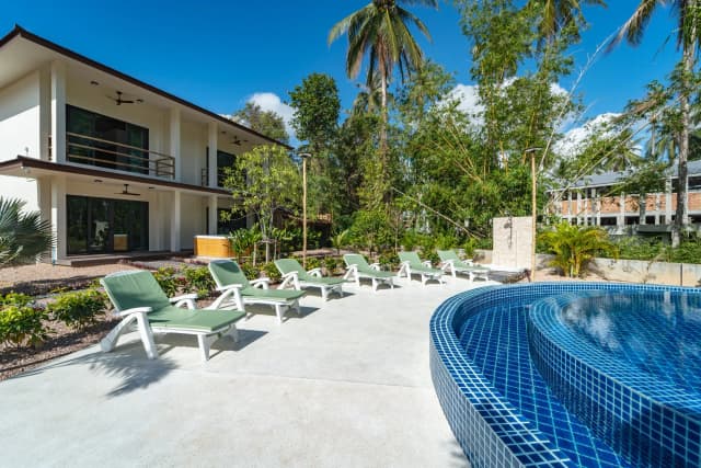 Pool with loungers and umbrellas at SHI Phangan